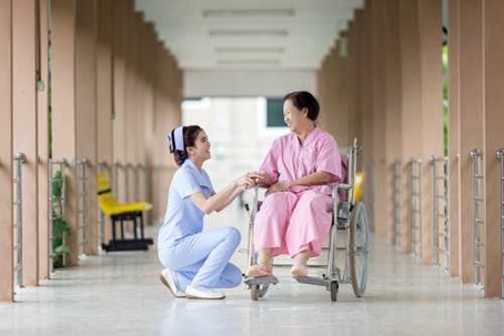Nurse with elderly woman in hospital