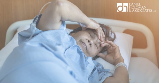 patient in bed holding head