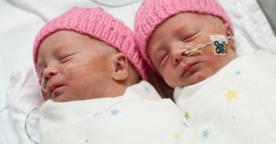Newborn, premature twin girls