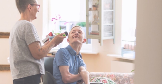 a boy with a birth injury talking to mother