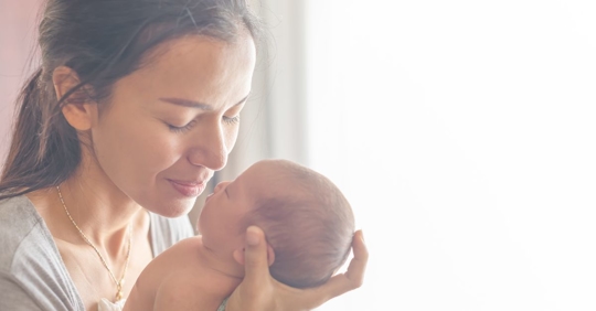 a mother holding her baby
