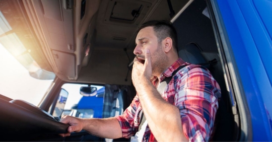 Truck driver yawning while driving