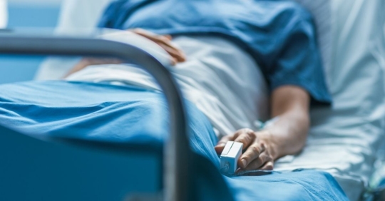 person lying in a hospital bed