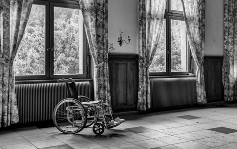 Black and white room with empty wheelchair