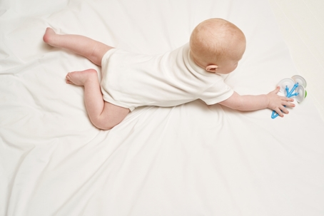 Baby reaching for a toy