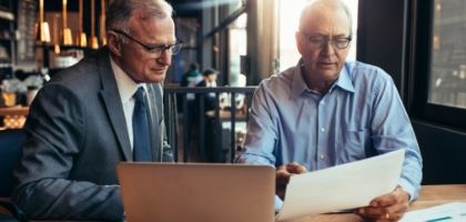Two men discussing and reviewing documents